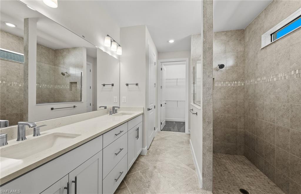 17039 Oakstead Drive Alva, FL 33920 - Photo 24 of 49 a spacious bathroom with a double vanity sink mirror double and shower