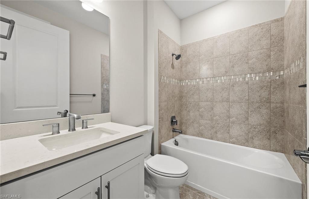 17039 Oakstead Drive Alva, FL 33920 - Photo 32 of 49 a bathroom with a sink a toilet and a bathtub