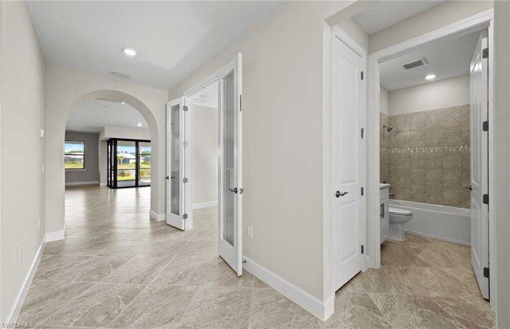 17039 Oakstead Drive Alva, FL 33920 - Photo 8 of 49 a view of a hallway with wooden floor and a bathroom