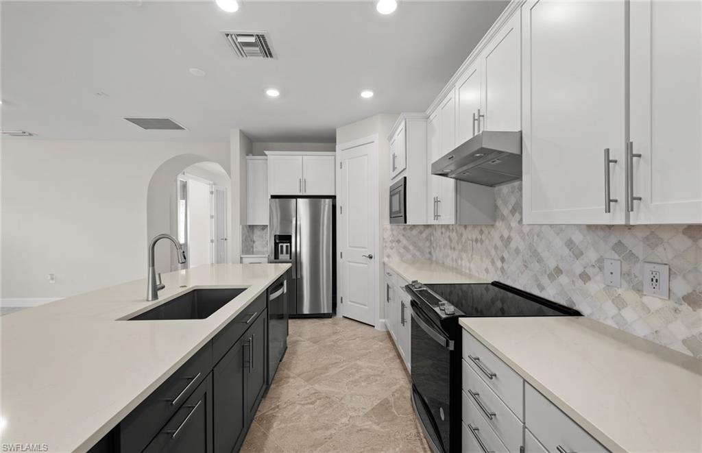 17039 Oakstead Drive Alva, FL 33920 - Photo 10 of 49 a kitchen with a sink stove and refrigerator