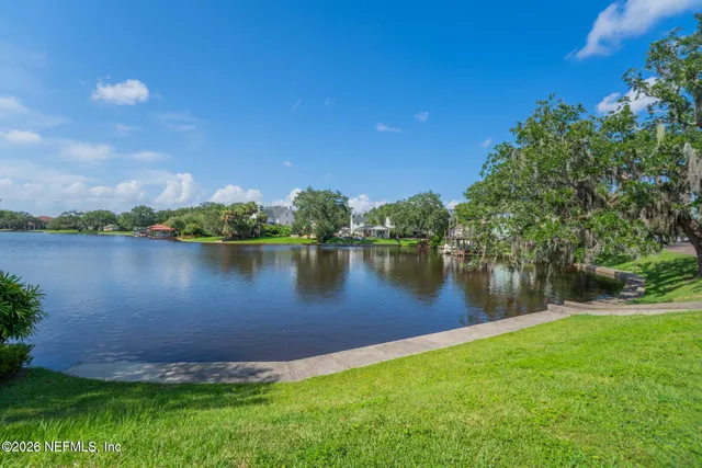 a view of a lake with houses in the back