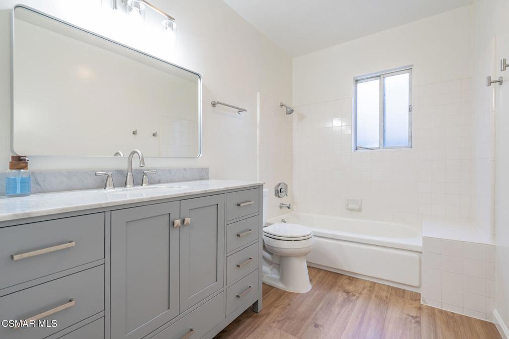 2085 Rayshire Street Thousand Oaks, CA 91362 - Photo 33 of 49 a bathroom with a toilet a sink a mirror and vanity