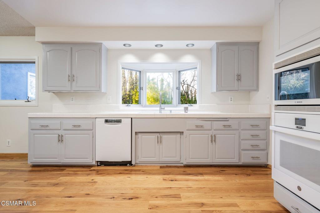 2085 Rayshire Street Thousand Oaks, CA 91362 - Photo 6 of 49 a kitchen with granite countertop a sink cabinets stainless steel appliances and a window