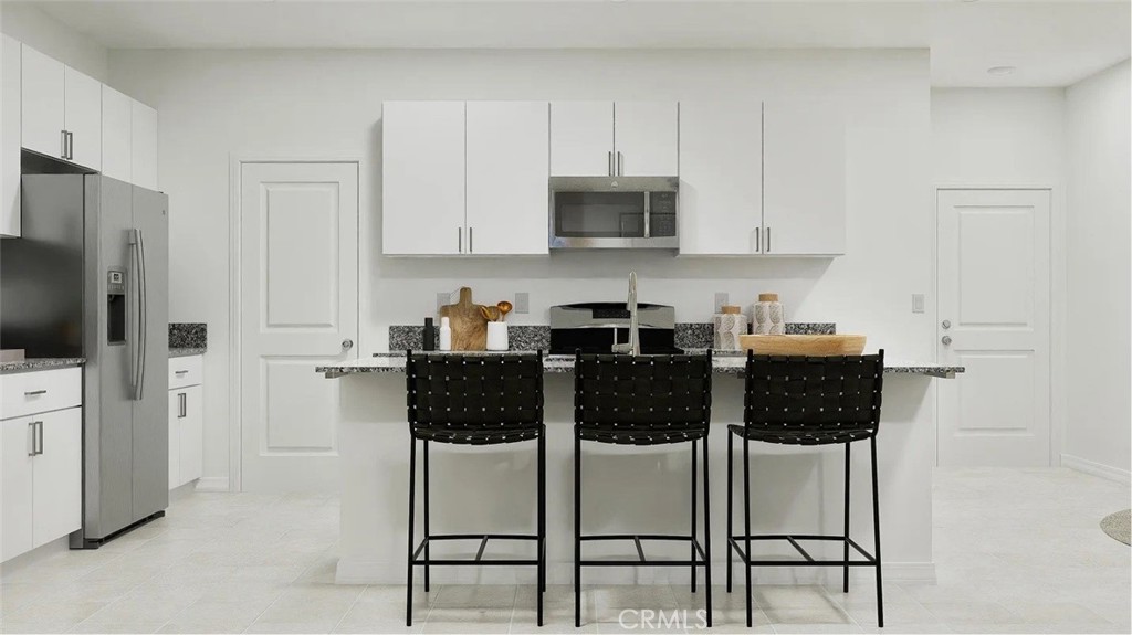 1216 Yeager Avenue Rialto, CA 92376 - Photo 1 of 17 a kitchen with stainless steel appliances a stove a sink a microwave and cabinets