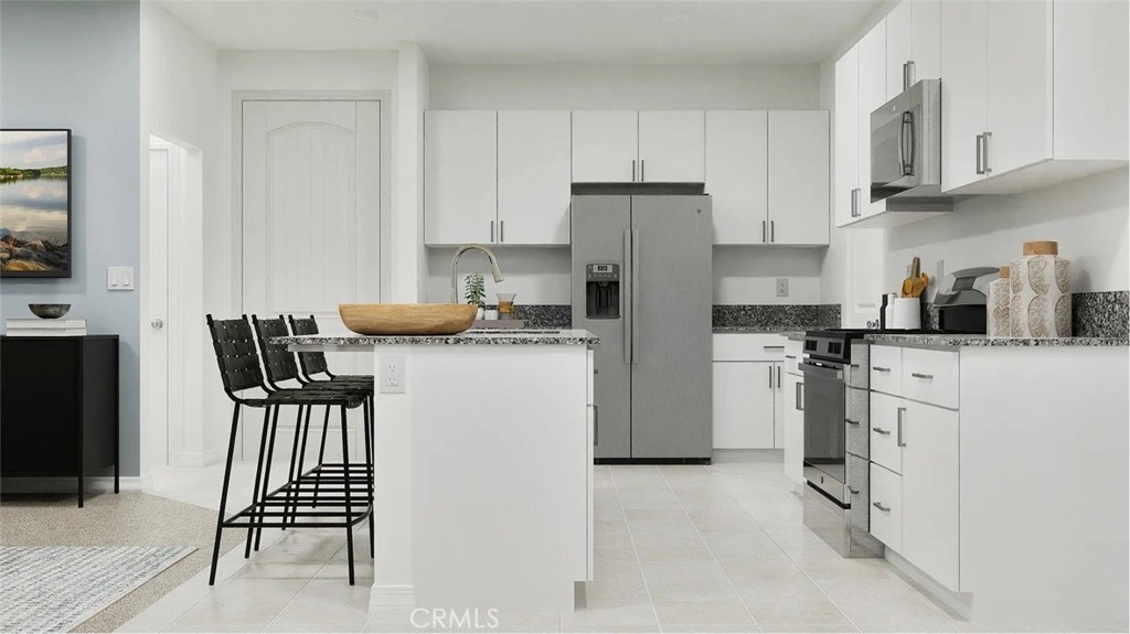 1216 Yeager Avenue Rialto, CA 92376 - Photo 2 of 17 a kitchen with a refrigerator and a stove top oven