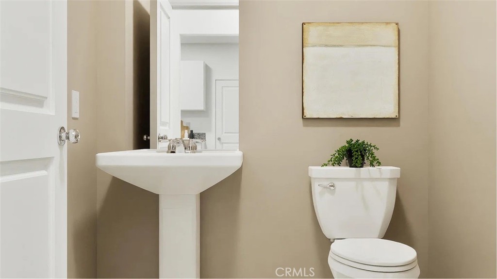 1216 Yeager Avenue Rialto, CA 92376 - Photo 8 of 17 a bathroom with a toilet sink and mirror