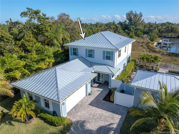 an aerial view of a house with a lake view