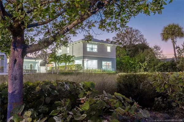 a view of a house with a yard and tree s