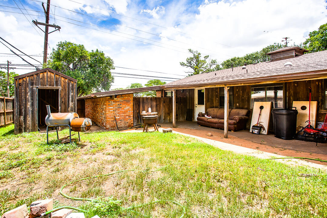 4402 28th Street Lubbock, TX 79410 - Photo 16 of 18 a backyard of a house with yard and barbeque oven