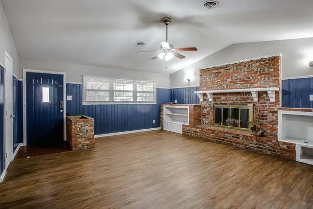 an empty room with furniture and a fireplace