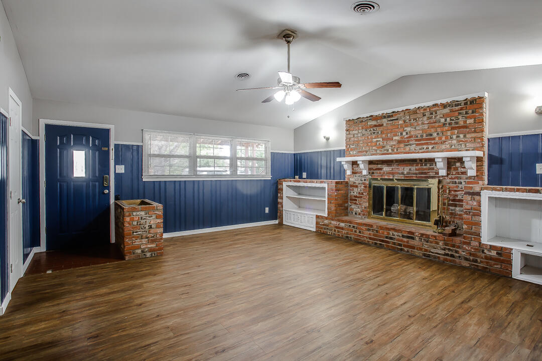 4402 28th Street Lubbock, TX 79410 - Photo 2 of 18 an empty room with furniture and a fireplace