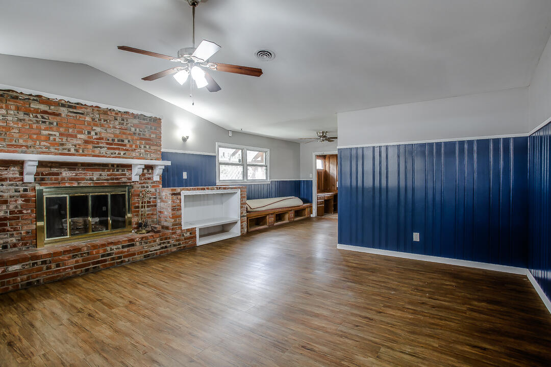 4402 28th Street Lubbock, TX 79410 - Photo 7 of 18 a view of livingroom with furniture chandelier fan and windows