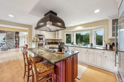 a kitchen with stainless steel appliances granite countertop a stove and a sink