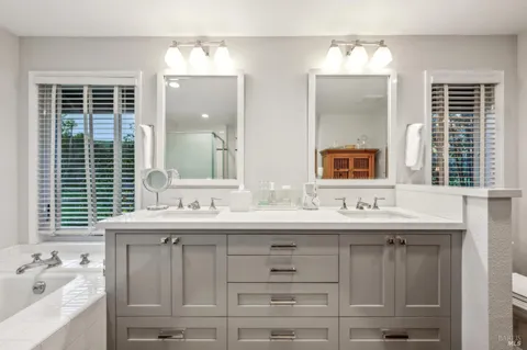 a bathroom with a sink double vanity and a mirror