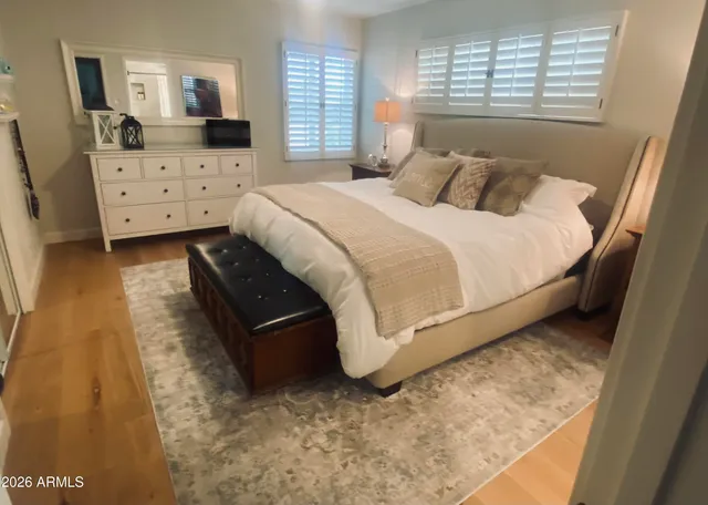 a large bed sitting in a bedroom next to a window