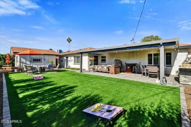 a view of a patio with table and chairs potted plants with wooden fence