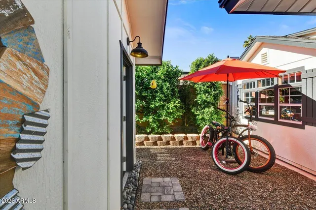 a view of a patio with table and chairs under an umbrella