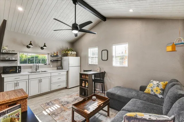 a living room with furniture and kitchen view