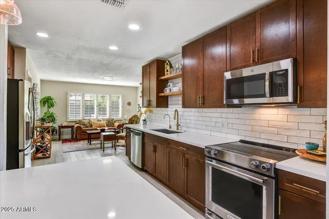 a kitchen with stainless steel appliances wooden cabinets and stove