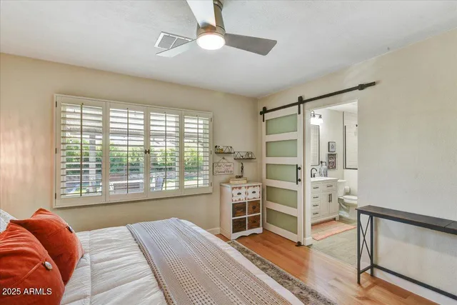 a bedroom with a bed and a large window with the outer view
