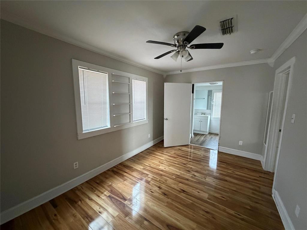 2240 Pin Oak Circle Haughton, LA 71037 - Photo 8 of 9 Unfurnished bedroom with light wood finished floors, crown molding, a ceiling fan, and ensuite bath