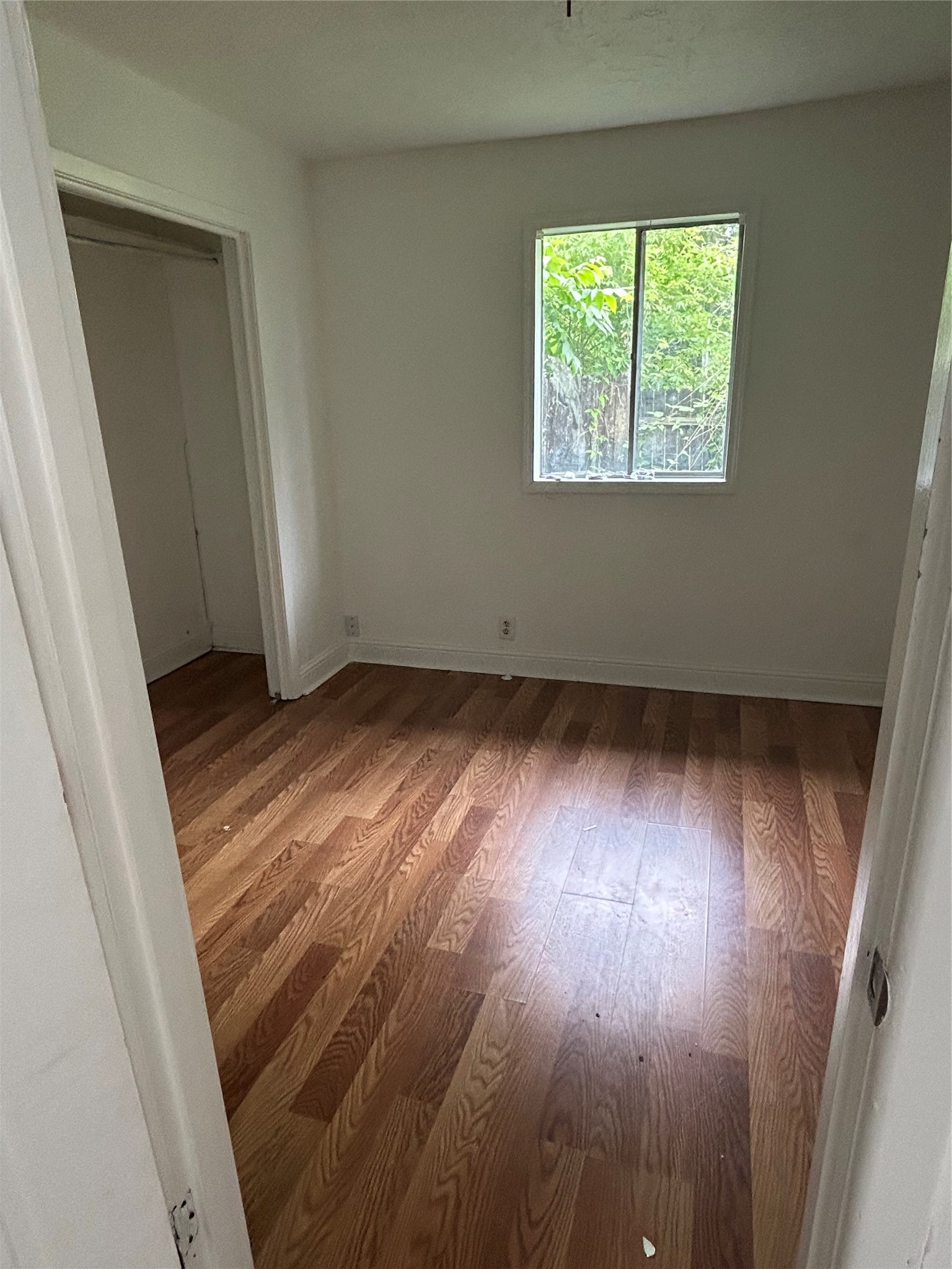 3040 Nineteenth Street Beaumont, TX 77706 - Photo 11 of 14 an empty room with wooden floor and windows