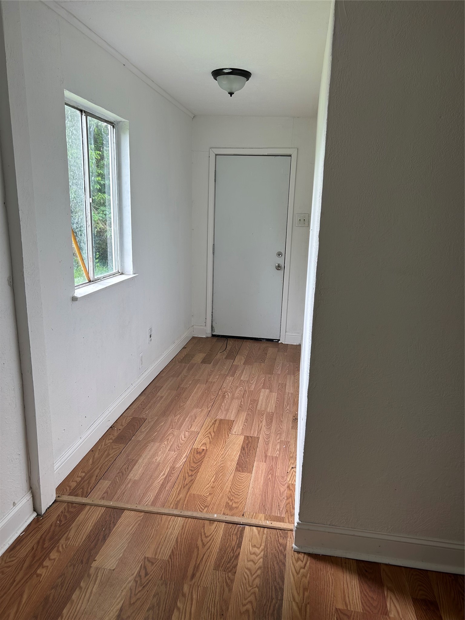 3040 Nineteenth Street Beaumont, TX 77706 - Photo 12 of 14 an empty room with wooden floor and windows