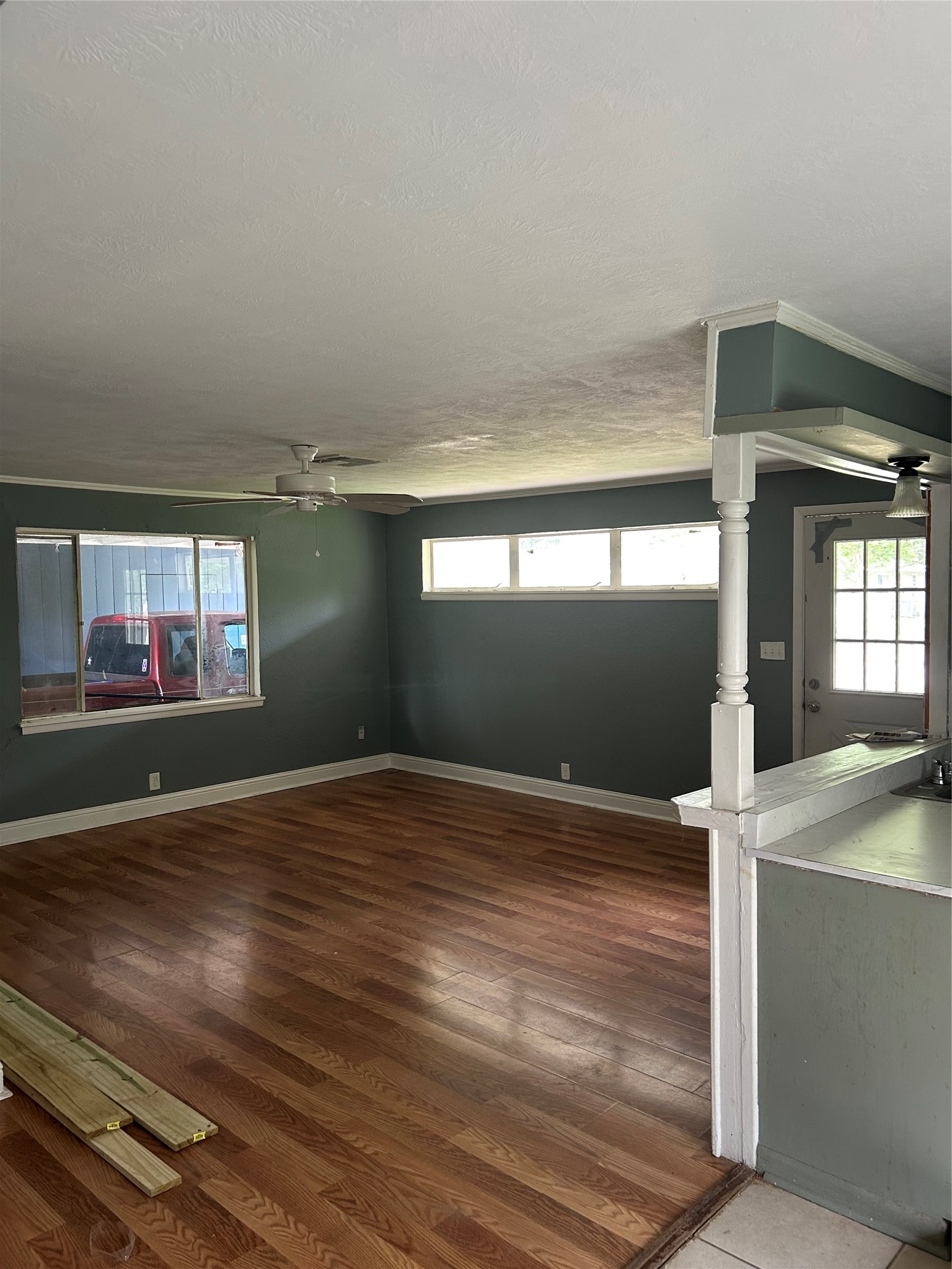 3040 Nineteenth Street Beaumont, TX 77706 - Photo 7 of 14 an empty room with wooden floor and windows