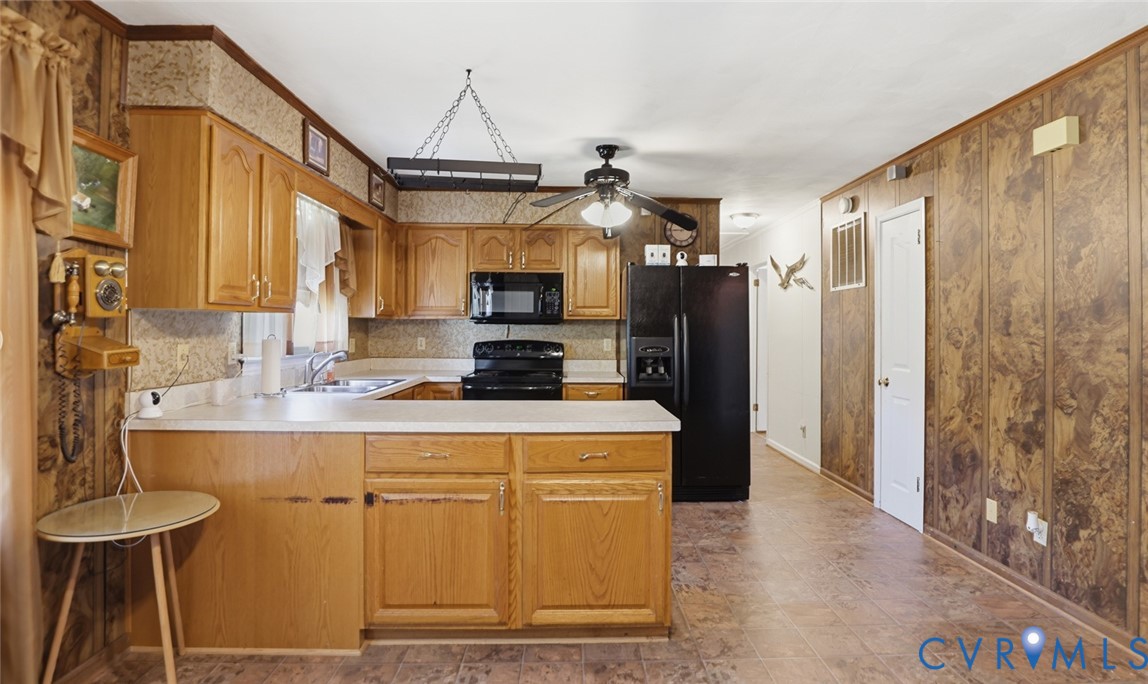 19353 Boulwares Road Ruther Glen, VA 22546 - Photo 21 of 62 Kitchen featuring light countertops, black applian