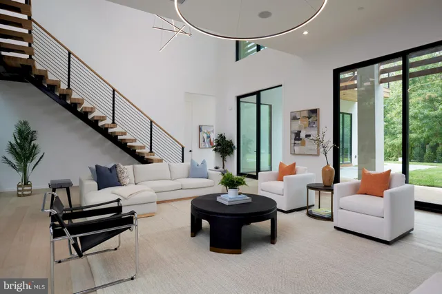 a kitchen with stainless steel appliances a dining table chairs and a microwave