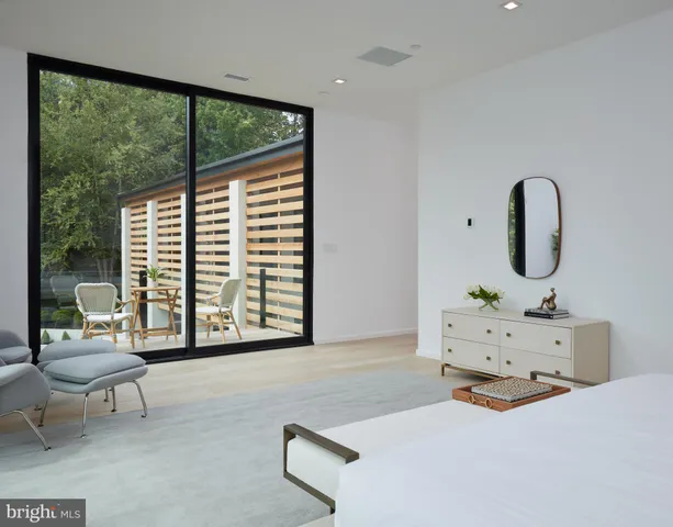 a view of a room with a large window and sitting space