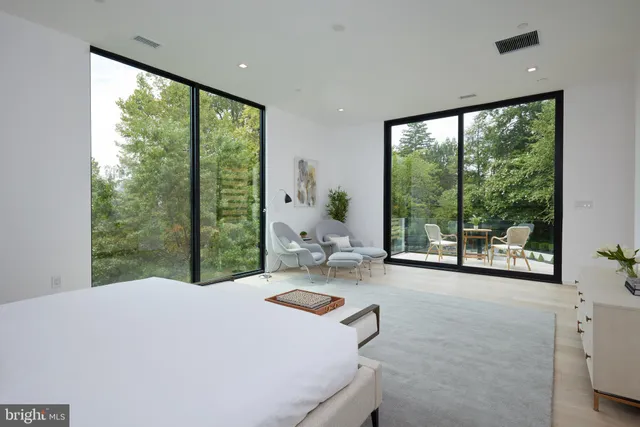 a view of swimming pool with chairs and wooden fence