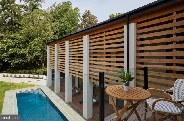 a view of empty room with wooden floor and windows