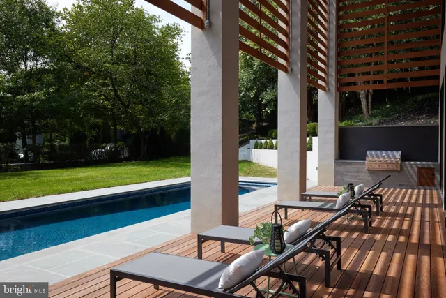 a living room with patio furniture and a potted plant