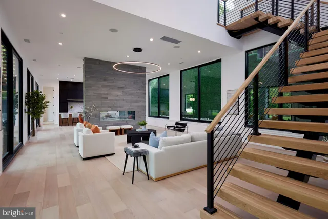 a living room with furniture ceiling fan and a large window