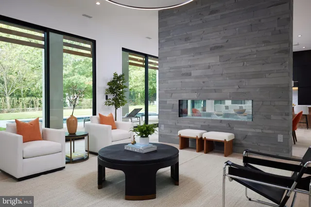 a dining room with furniture and a large window