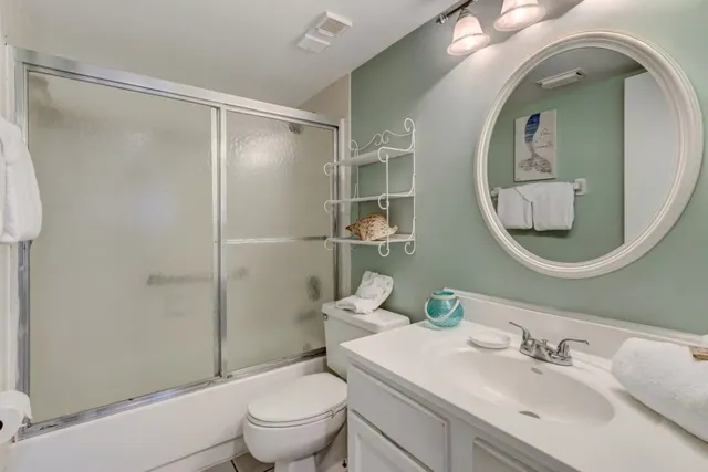 a bathroom with a sink toilet and a mirror