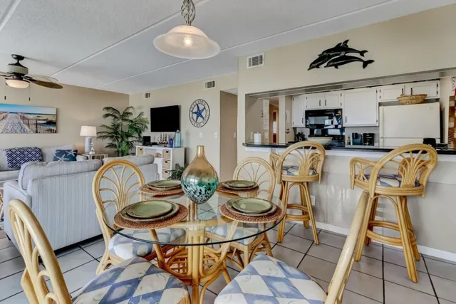 a dining room with furniture a window and kitchen view