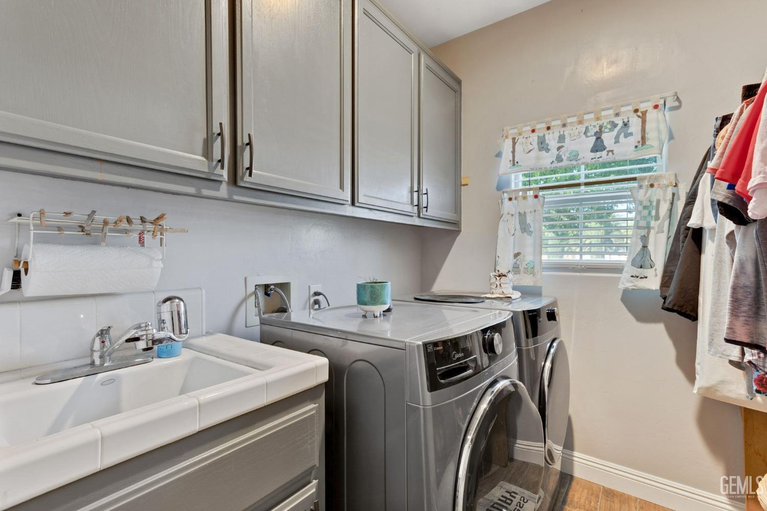 Undisclosed Address Bakersfield, CA 93314 - Photo 13 of 36 a view of a kitchen with sink washer and dryer
