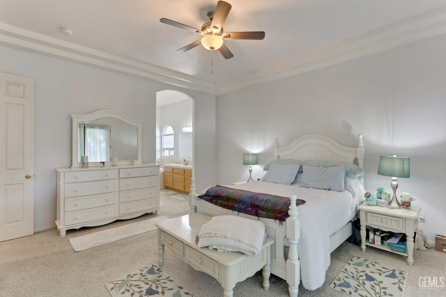 Undisclosed Address Bakersfield, CA 93314 - Photo 16 of 36 a bedroom with a bed and a chandelier