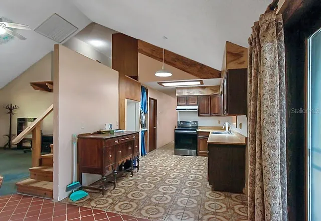 a kitchen with stainless steel appliances kitchen island granite countertop a sink and cabinets