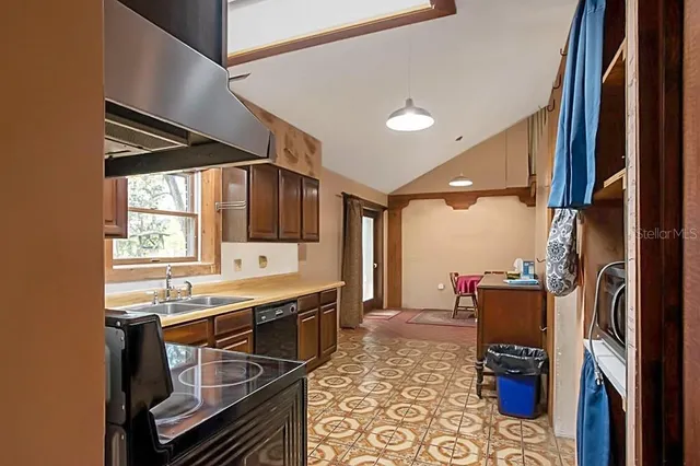 a kitchen with a sink appliances and cabinets