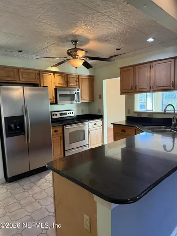 a kitchen with a sink and a stove top oven