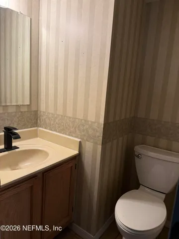 a view of an empty room with a fireplace and a window