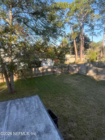 a view of a backyard of the house