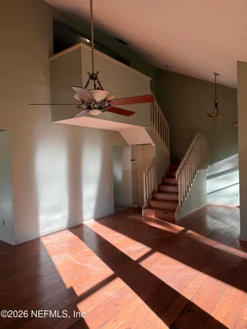 a view of entryway and hall with wooden floor