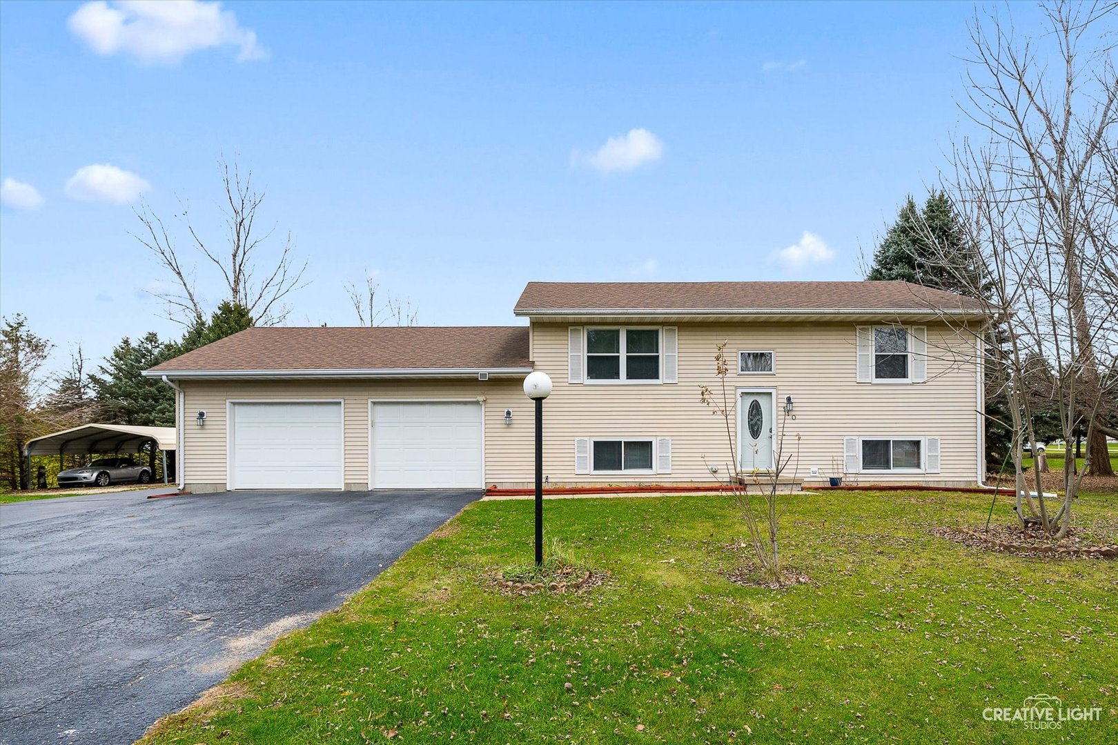 110 Windward Lane Rochelle, IL 61068 - Photo 1 of 23 a view of a house with a yard and sitting area