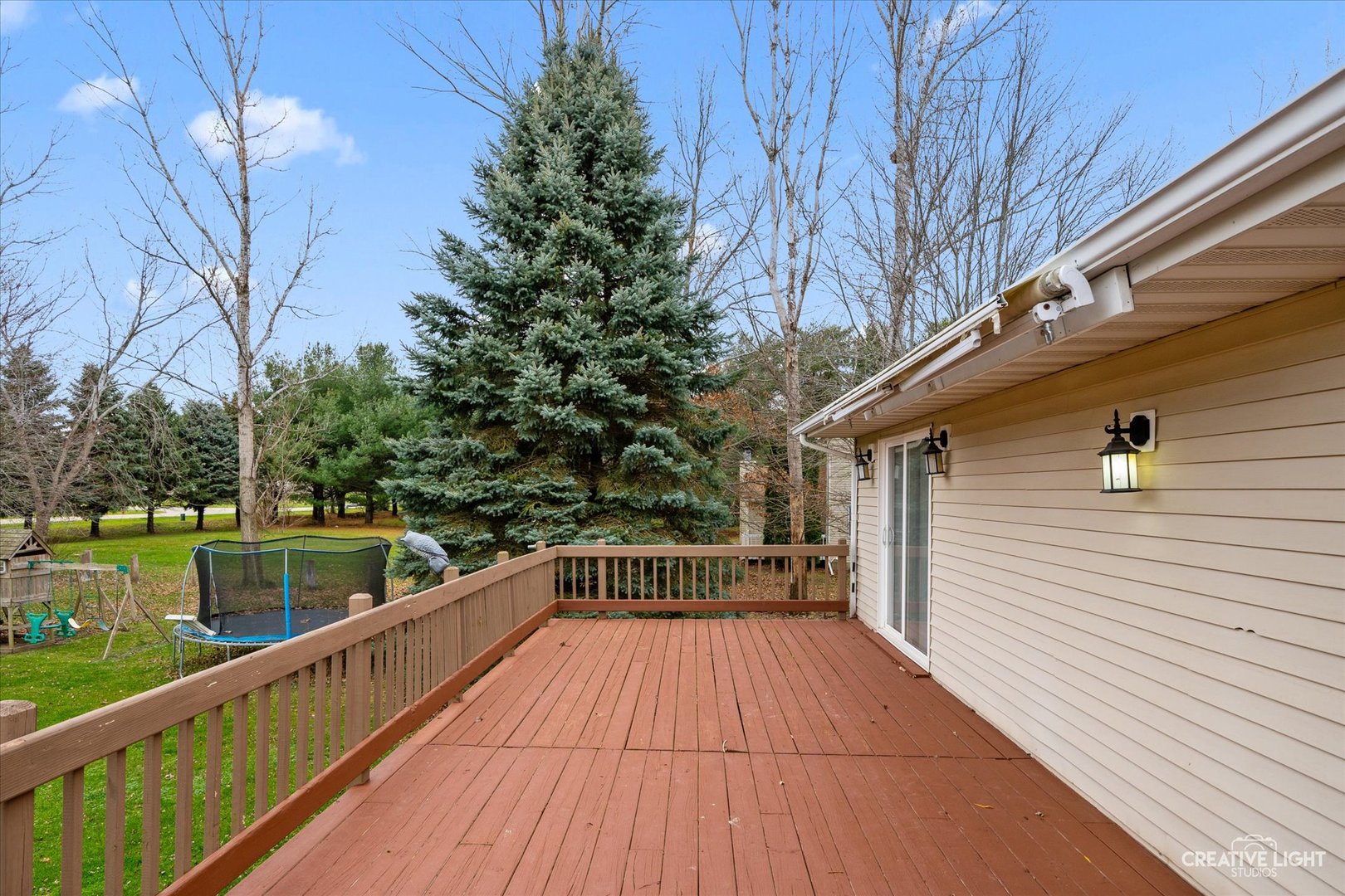 110 Windward Lane Rochelle, IL 61068 - Photo 20 of 23 a view of balcony with wooden floor and trees in the back