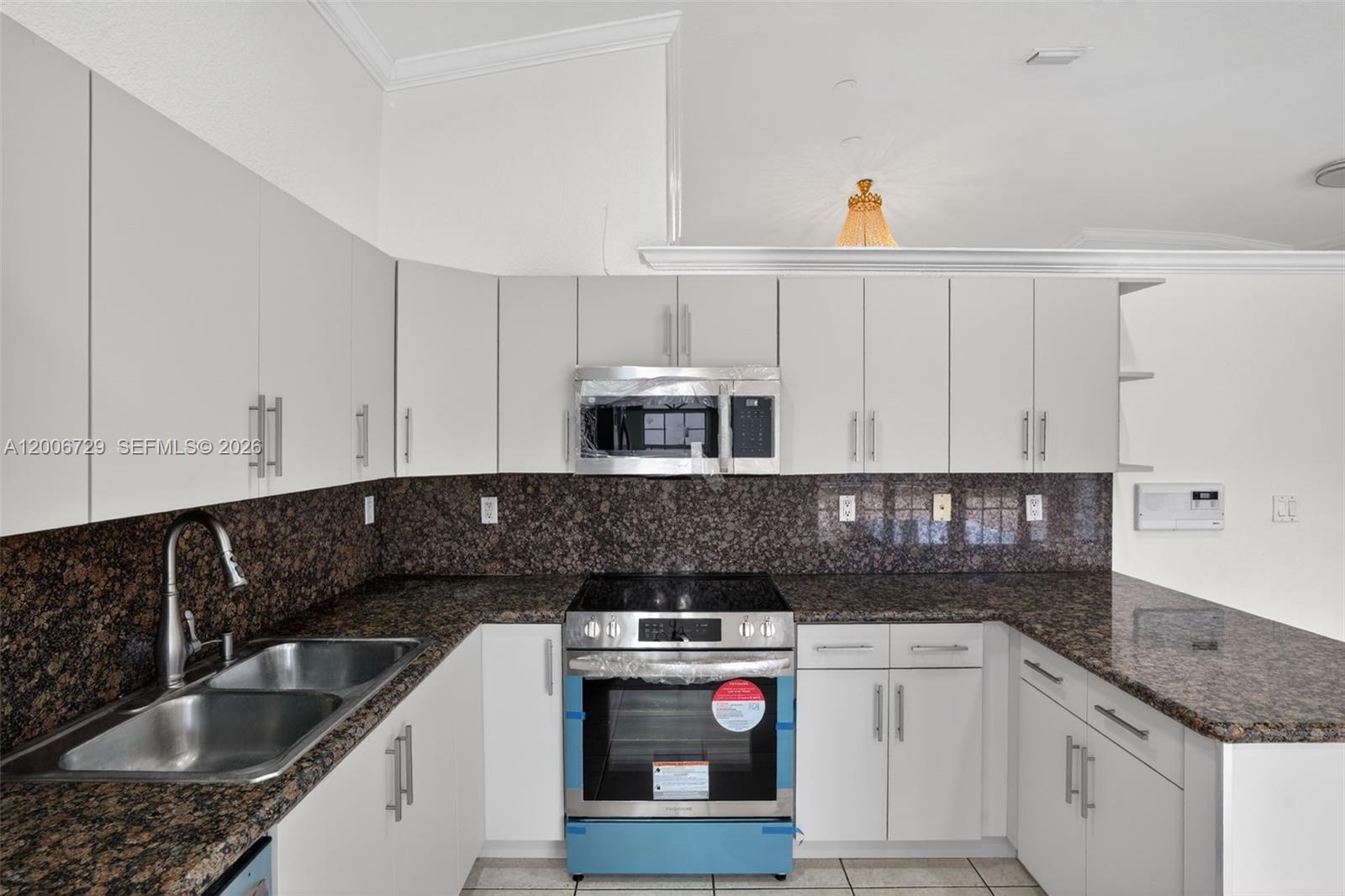 14251 Southwest 34th Street Miami, FL 33175 - Photo 16 of 54 a kitchen with stainless steel appliances granite countertop a sink and a stove