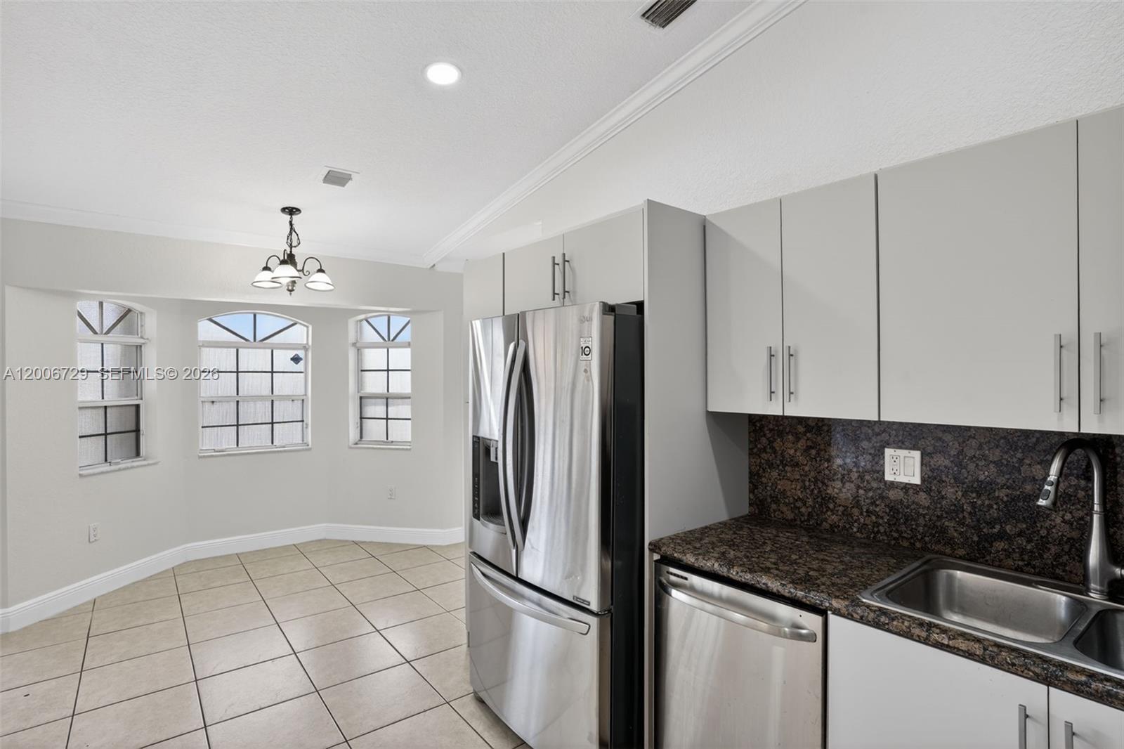 14251 Southwest 34th Street Miami, FL 33175 - Photo 17 of 54 a kitchen with granite countertop a refrigerator sink and cabinets